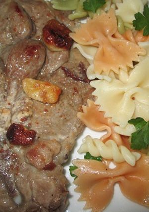A picture of Garlic Pork Chops with Mixed Buttered Pasta.