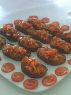 Una foto de Brucheta o pan tostado con tomate y perejil