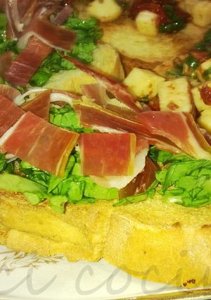 Una foto de Bruschettas con rúcula y jamón crudo 