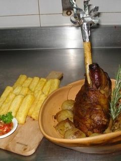 Una foto de Gigot braseado con cebollas, hinojos y papas bastón