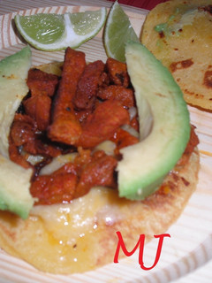 A picture of Tacos al Pastor with Orange Juice and Pineapple.