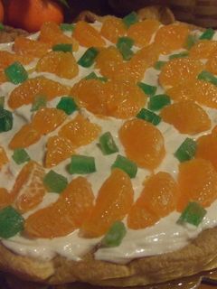 Una foto de Tarta de nueces con queso crema y mandarinas