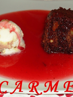 Una foto de Brownies con salsa de fresas caliente y helado