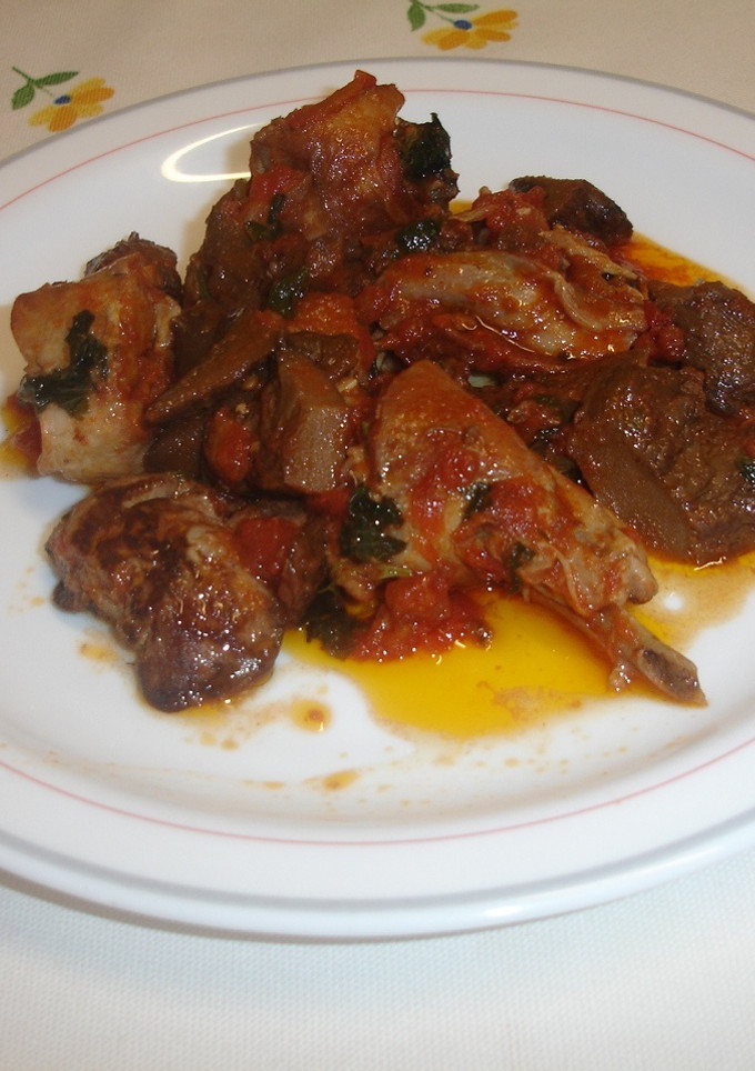 Una foto de Conejo con tomate y robellones