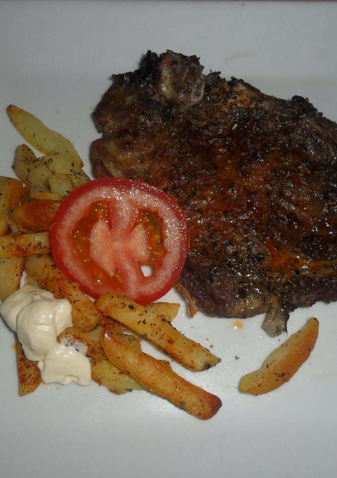 Una foto de Chuletas de cerdo y patatas a las especias