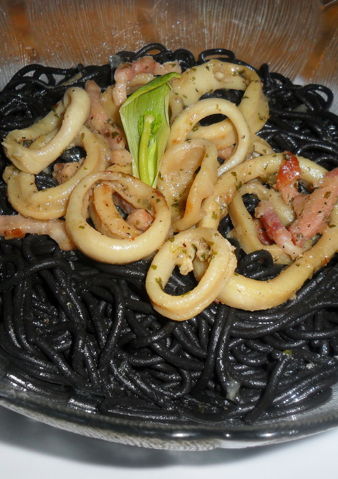Una foto de Espaguetis negros con anillas de pota y bacon