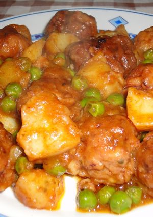 Una foto de Albóndigas de calamar con guisantes y patatas