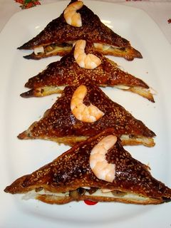 Una foto de Mil hojas de langostinos y champiñones