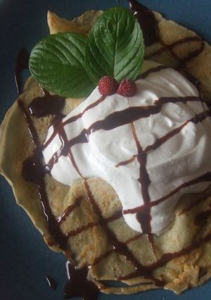 Una foto de Crêpes rellenas de crema de quark y yogurt con salsa de chocolate