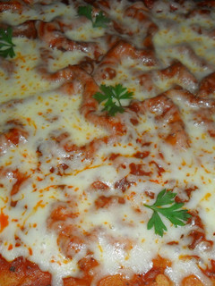 Una foto de Pizza casera con tomate y queso