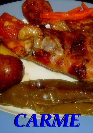 Una foto de Cabrito al horno con pimientos y patatas asadas