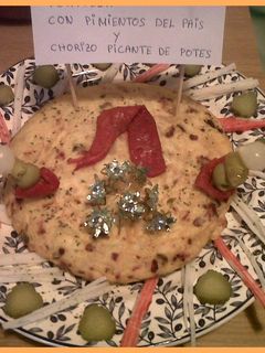 Una foto de Tortilla de pimientos del país y chorizo picante de potes