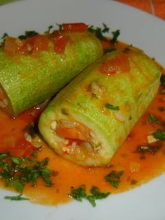 Una foto de Calabacines rellenos de arroz y verduras en salsa de tomate