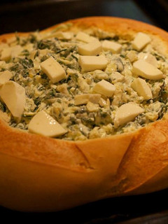 Una foto de Pan relleno de queso, espinacas y alcachofas
