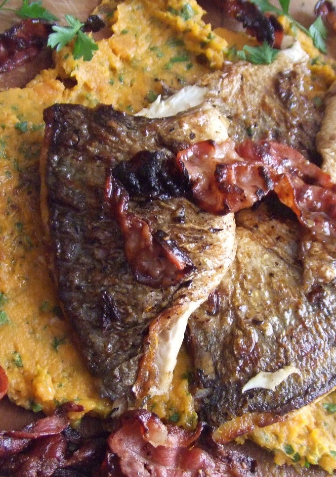Una foto de Pescado crujiente en tabla con puré de boniatos