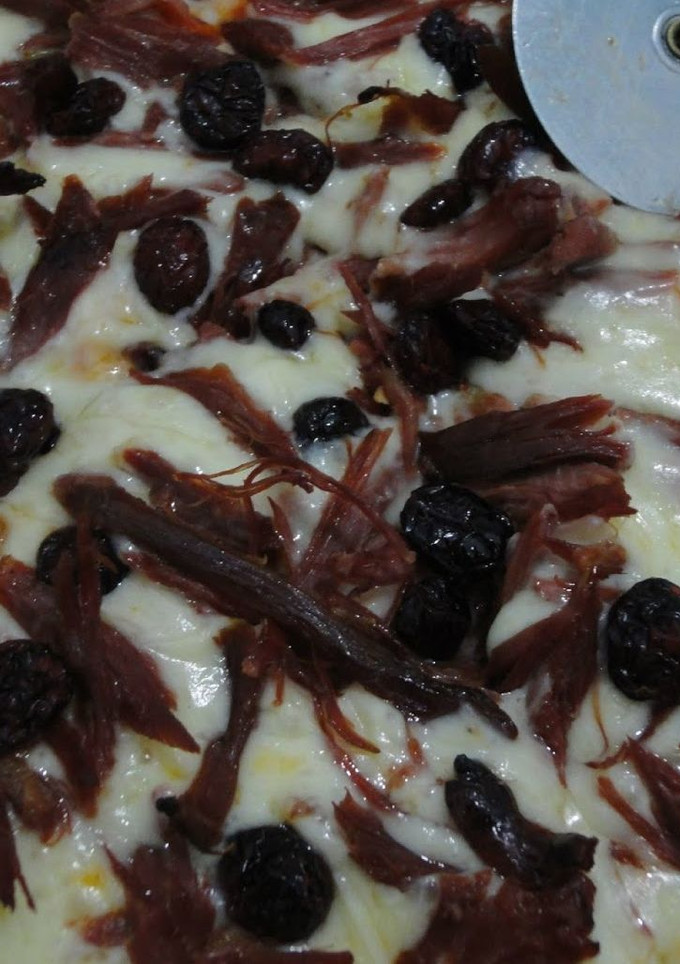 Una foto de Pizza de pato y arándanos