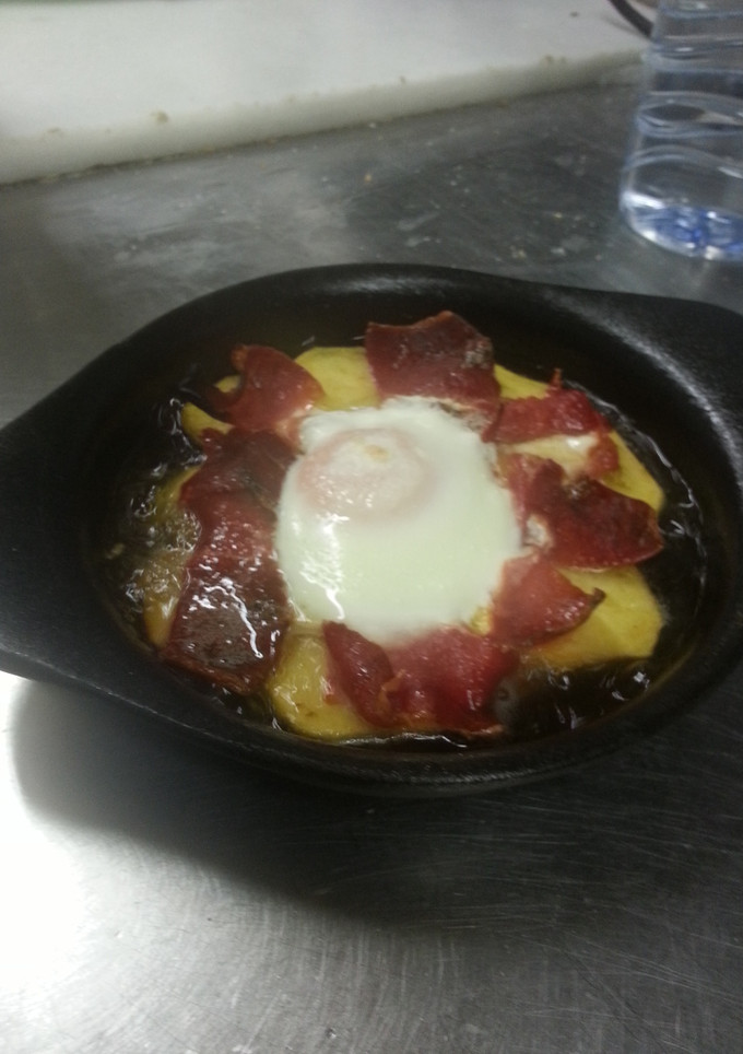 Una foto de Patatas ibéricas con huevo a caballo