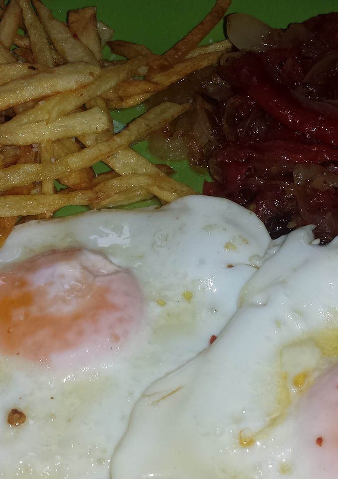 Una foto de Huevos fritos con pimientos y cebolla