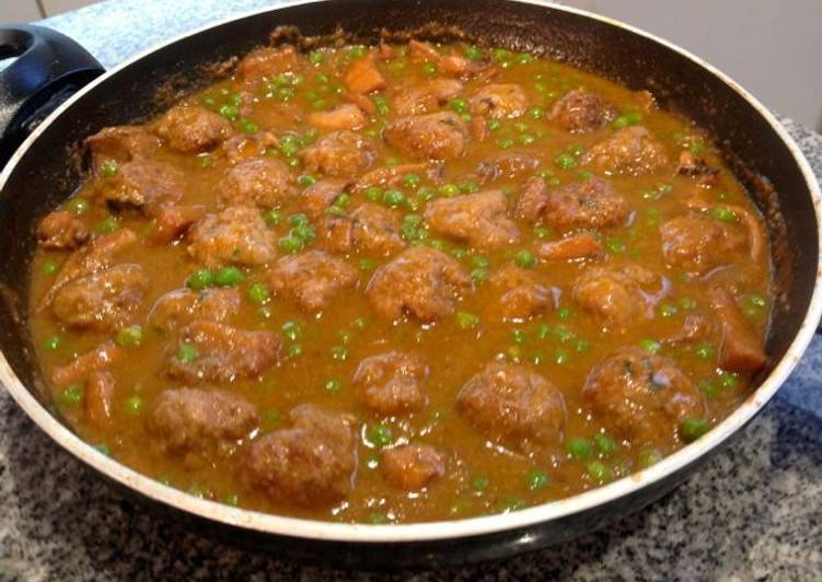 albondigas en salsa de tomate frito y guisantes
