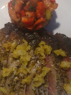 Una foto de Atún a la pimienta con tartar de tomate y fresas