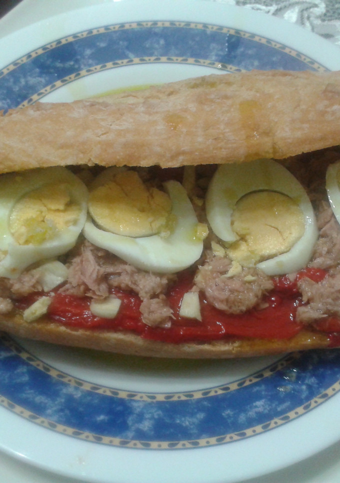 Una foto de Bocadillo de pimientos rojos asados con ajitos, atún y huevo
