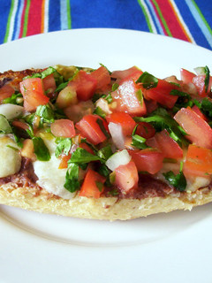 Una foto de Molletes con frijoles refritos y pico de gallo