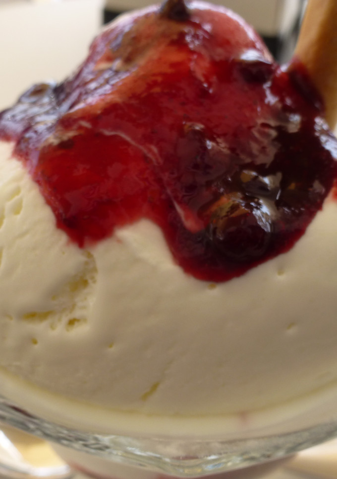 Una foto de Helado de yogur con salsa de frutos rojos