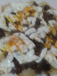 Una foto de Patatas a lo pobre con morcillas y huevos rotos