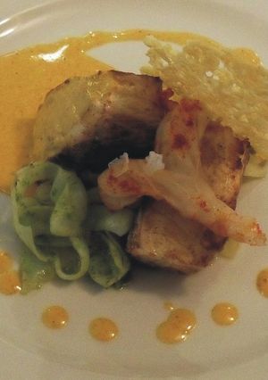 Una foto de Lomo de corvina con heliscristo, crujiente de queso de cabra y tallarines de choco