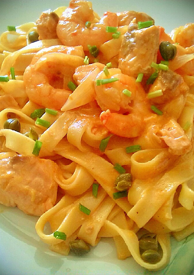 Una foto de Tallarines con salmón fresco, langostinos y alcaparras