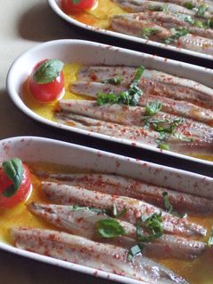 Una foto de Aperitivo de boquerones en vinagre con tomatitos y albahaca
