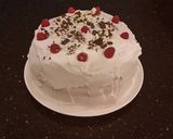 A picture of step 32 of White Layer Cake with a Raspberry Swirl Cheesecake center layer and a Raspberry Cream Frosting.