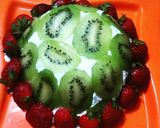 A picture of step 9 of Lemon cake pudding with upside down kiwi whipped cream frosting.