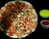 A picture of step 7 of Rava Uttapam with veggies, packed with fruits and dryfruits.
