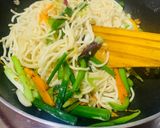 A picture of step 4 of Veg Hakka noodles with spring onions.
