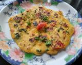 A picture of step 7 of Besan onion tomato chilla.
