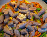 A picture of step 6 of Keto Wors and Sweet Peppers.