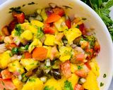 A picture of step 2 of Loaded Nachos with Mango Salsa, Sour cream and cheese sauce.
