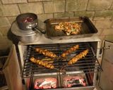 A picture of step 6 of Chicken satay kebabs and home made pili pili cheesy chapati nachos in the jiko oven :).