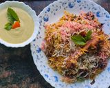 A picture of step 8 of Smokey tandoori chicken drumsticks biryani with mint mango raita.