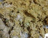 A picture of step 1 of Parsley Lauki muthiya topped with pizza sezhwan sauce.
