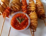 A picture of step 6 of Spiral potato and carrots on stick.