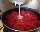 A picture of step 2 of Gajar Ka Halwa with milk and cashews.