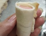 A picture of step 2 of (Snack) Fried Sandwich-Wrapped Sausages.