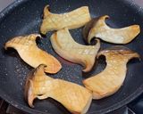 A picture of step 4 of King oyster mushrooms sautéed in soy butter.