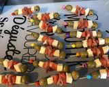 A picture of step 6 of Appetizer Skewers with Green Olives, Tomato, Prosciutto, and Pyrenees Cheese.