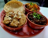 A picture of step 4 of Ashtami Bhog Thali (Halwa, Puri, Kala Chana).