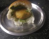 A picture of step 5 of Vadapav with green spicy chutney.