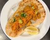 A picture of step 7 of Chicken tikka on naan with fragrant salad.