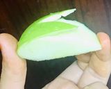 A picture of step 2 of Bunny- shaped green apple wedges.